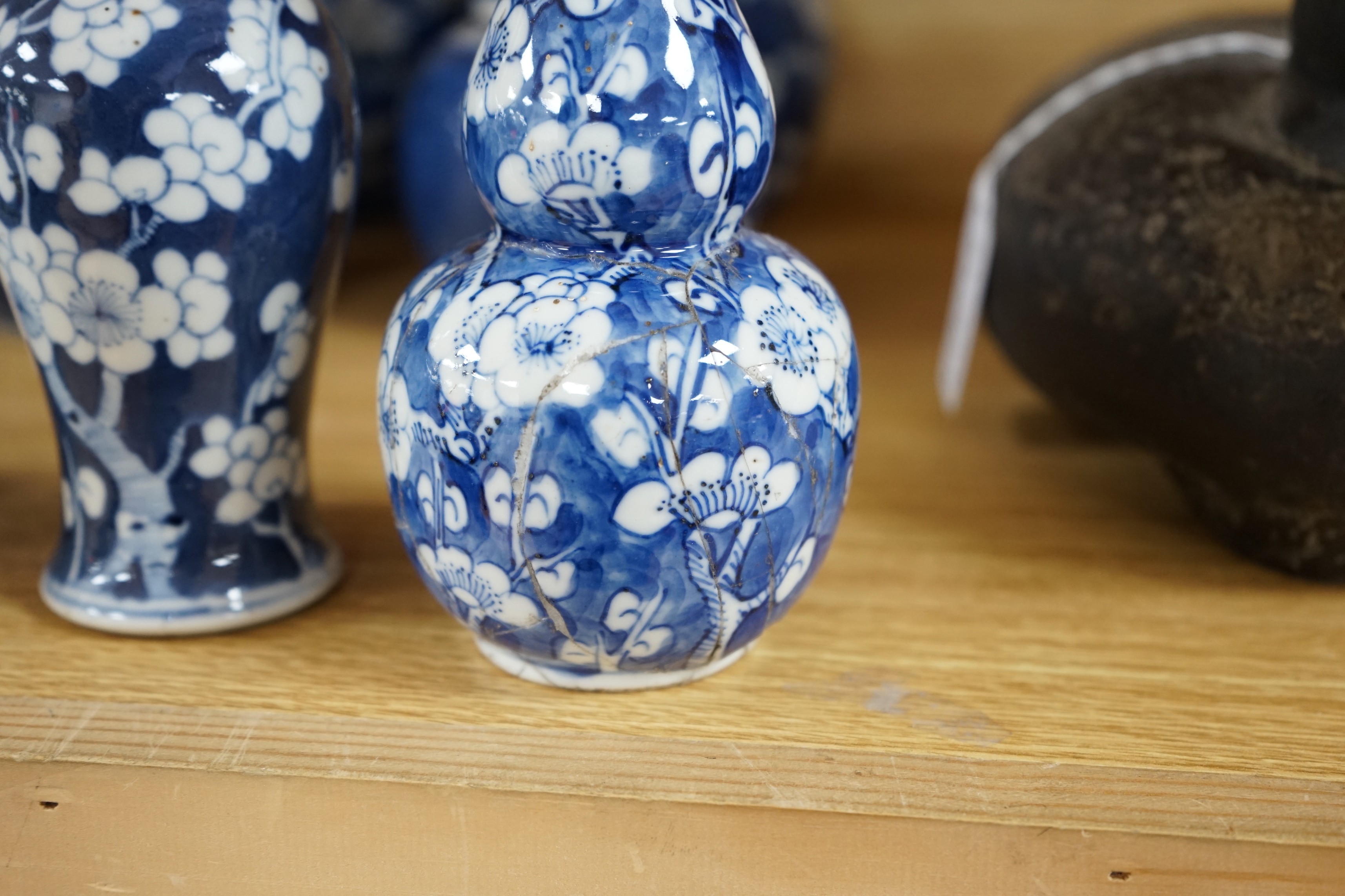 Four Chinese blue and white prunus pattern ginger jars, together with three similar vases. 19th/early 20th century, Tallest 15cm